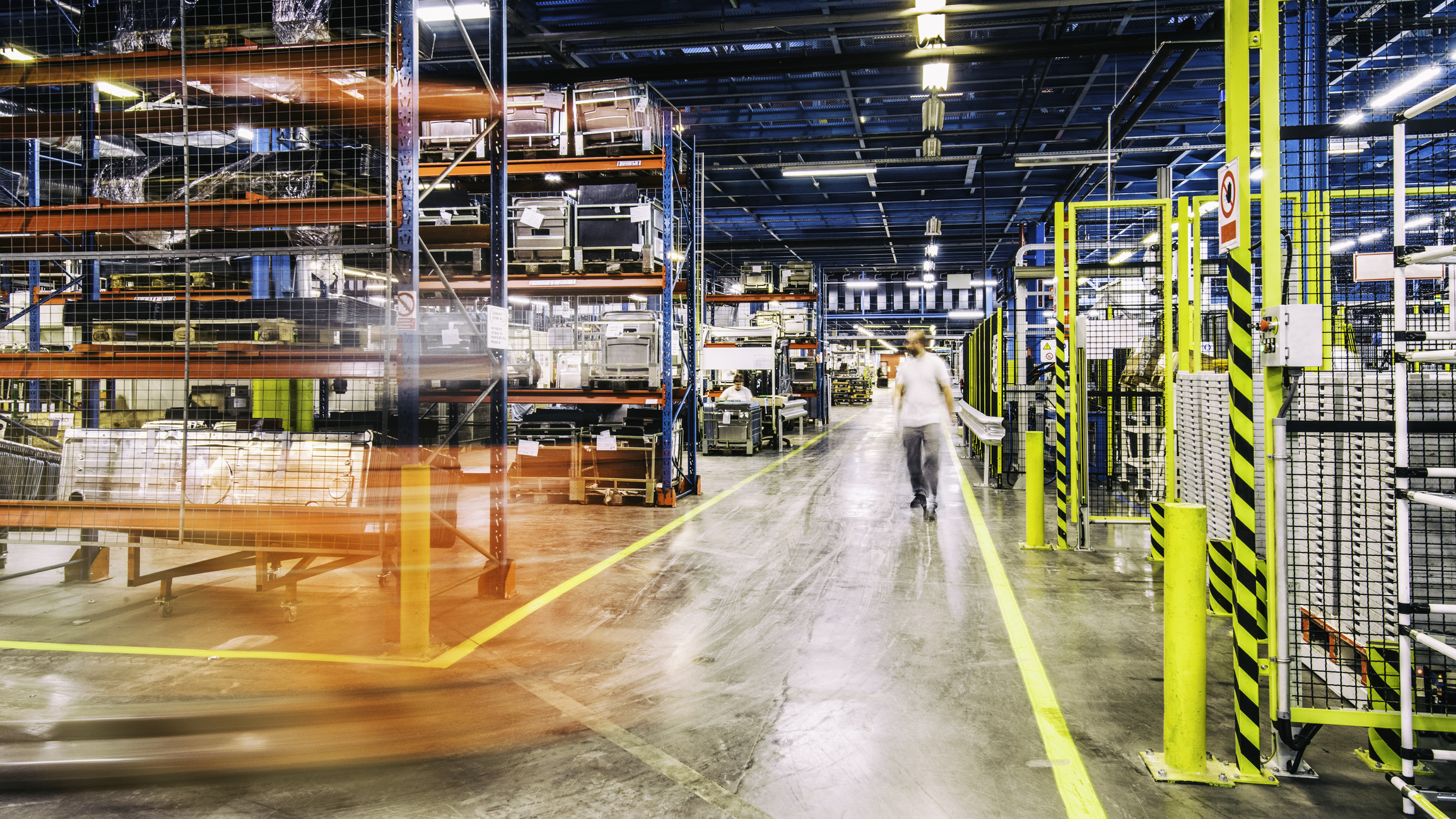 Forklift driving around in a factory.